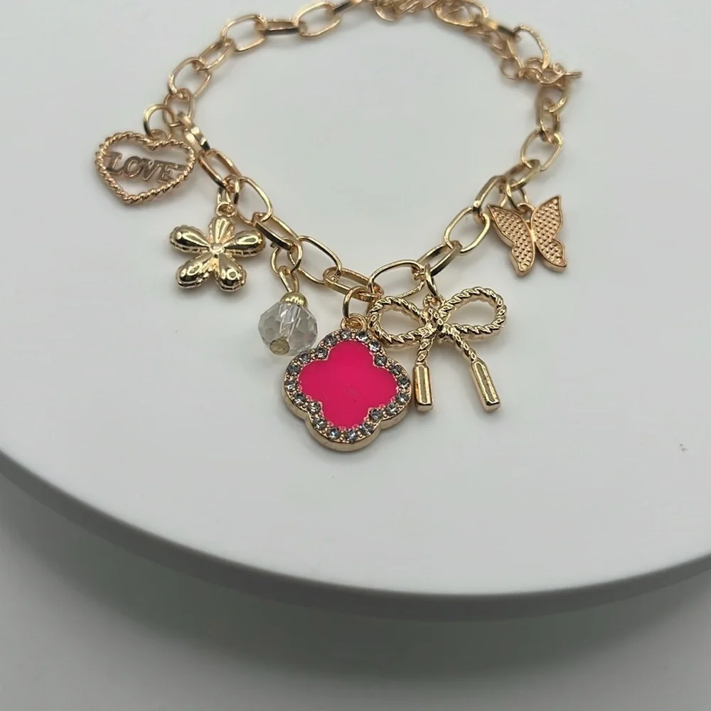849. Gold Charm Bracelet with Pink Accent
